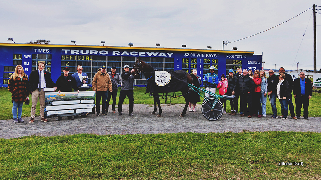 Chip Of Evil and her connections in the winner's circle at Truro Raceway