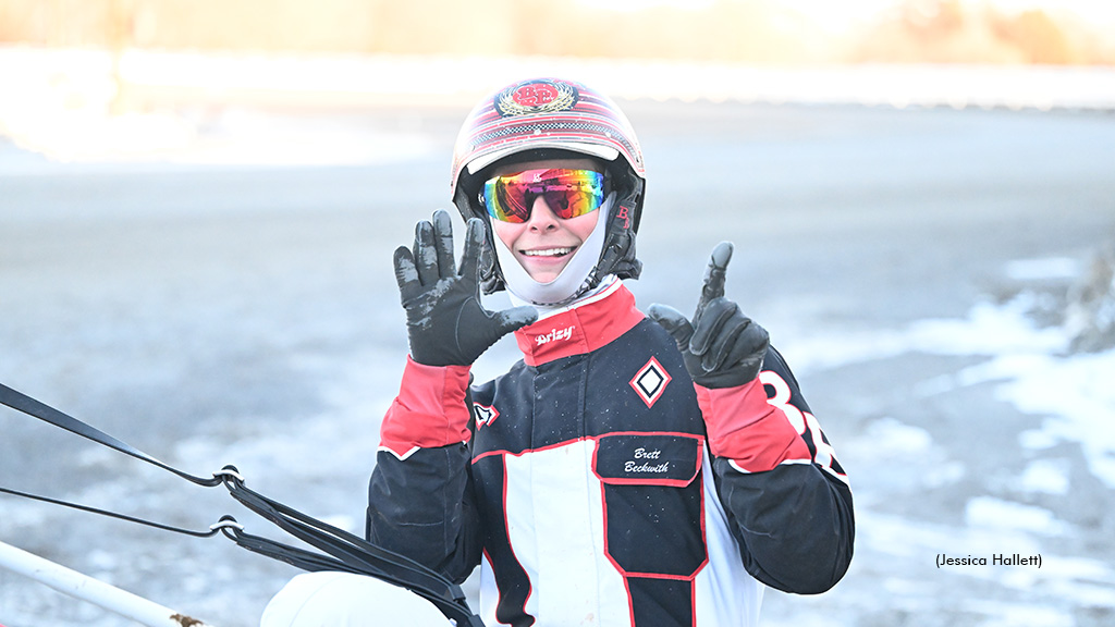 Brett Beckwith holds up seven fingers after driving seven winners on the weekday program