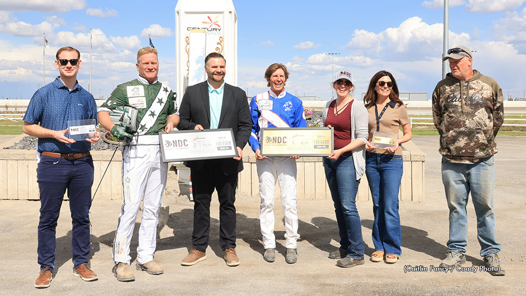 Phil Giesbrecht and Kelly Hoerdt receive commemorative NDC tickets