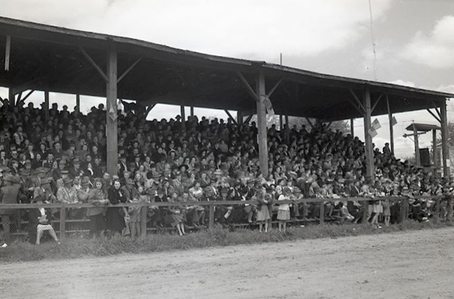 A crowd in a wooden grandstand