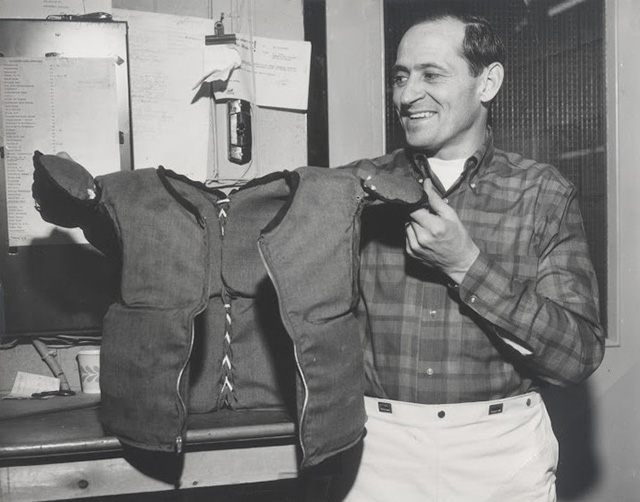 Bob Farrington holding up a vest