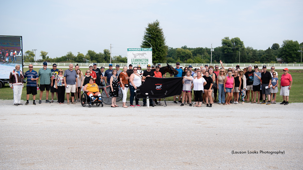 Family and friends of the late Bob McIntosh gather in the Leamington Raceway winner's circle