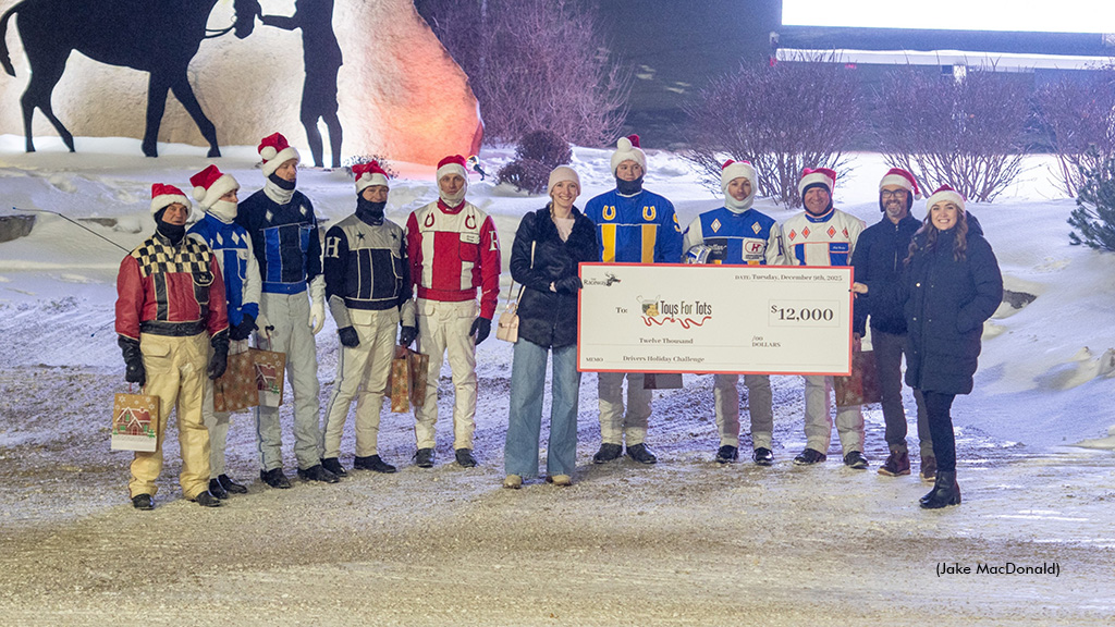 A cheque presentation to Toys For Tots with all drivers