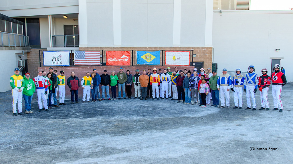 A group of horsepeople in the winner's circle