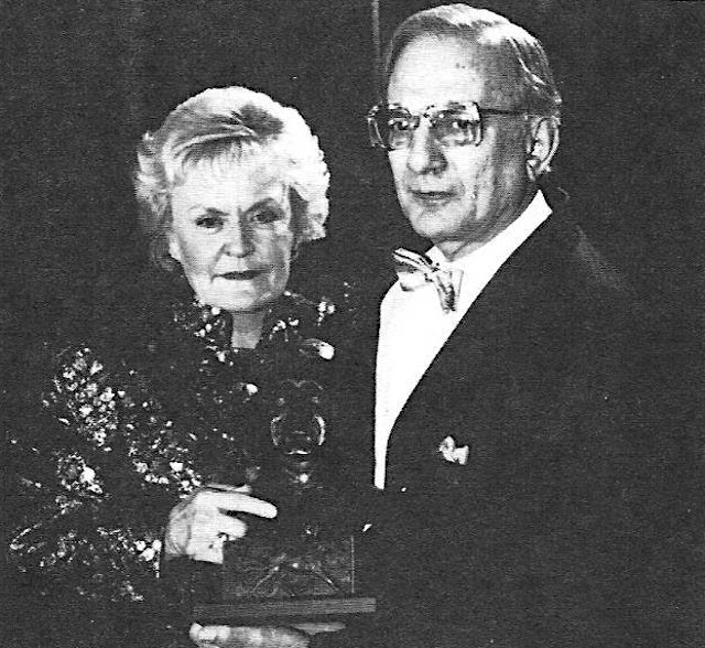 Stan Bergstein presents a trophy to Ilene O'Brien