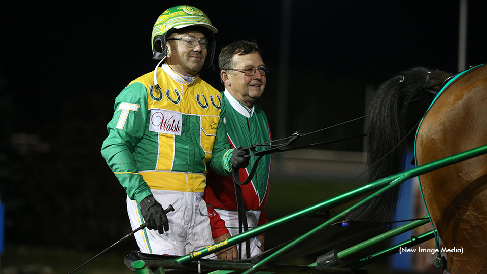 Trainer Jim King Jr. and driver Tim Tetrick after Lyons Sentinel's elimination win