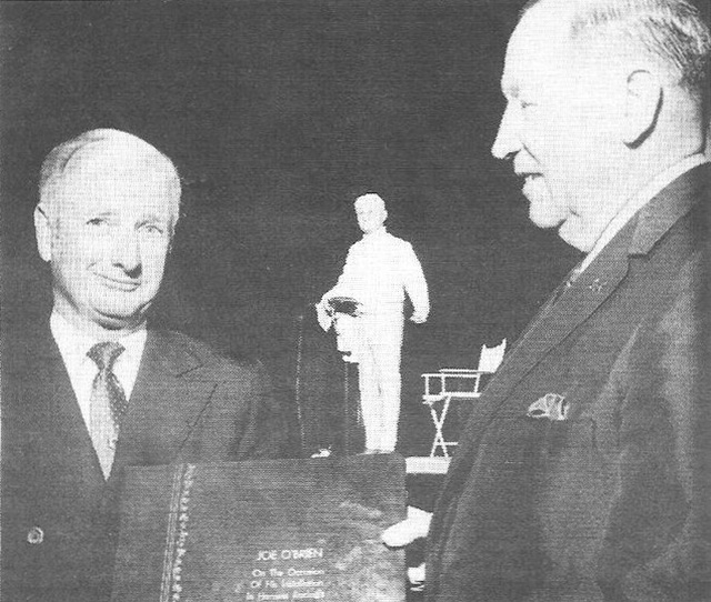 Allan Dickenson hands Joe O'Brien his Hall of Fame book