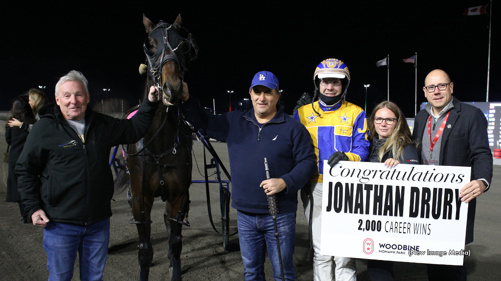 Jonathan Drury celebrates his 2,000th career driving win on Nov. 30 in the winner's circle at Woodbine Mohawk Park