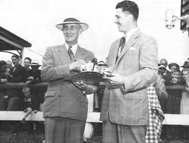 Ken MacKinnon receives a trophy from Wick Fraser