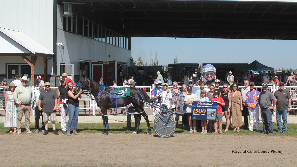 Mike Hennessy being presented with a 1,500-win placard