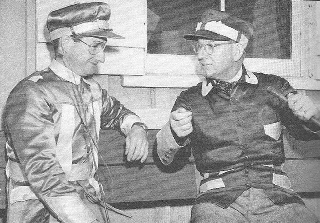 Joe O'Brien and Charlie Mills talk on a  bench