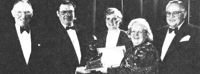 A group of people with an O'Brien trophy