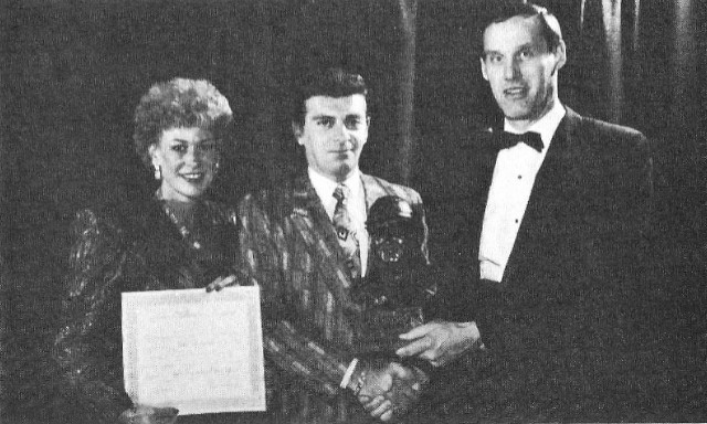 Three people with an O'Brien trophy