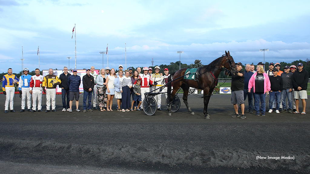 Paul MacDonell and a large group of family and friends in the winner's circle
