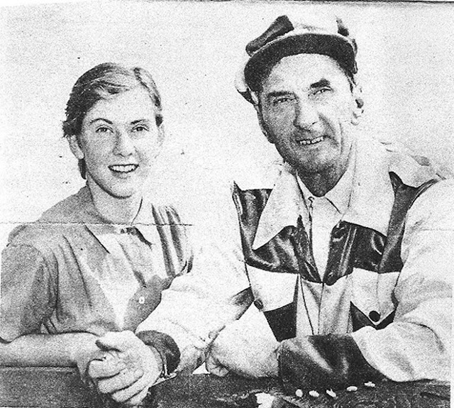 A man in driving colours with a young woman