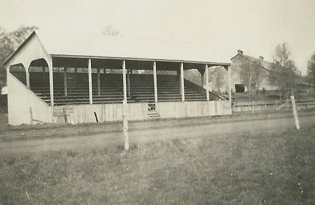 A grandstand in front of a small track