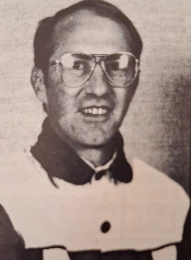 An upper body picture of a man in driving colours
