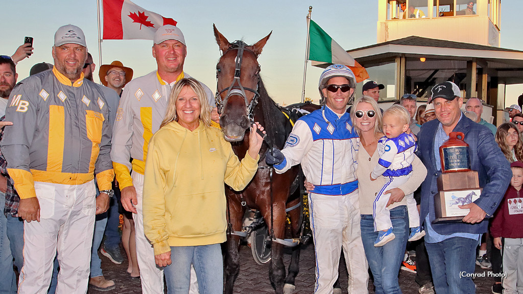 Ron Burke in the winner's circle with Little Brown Jug champion Bythemissal