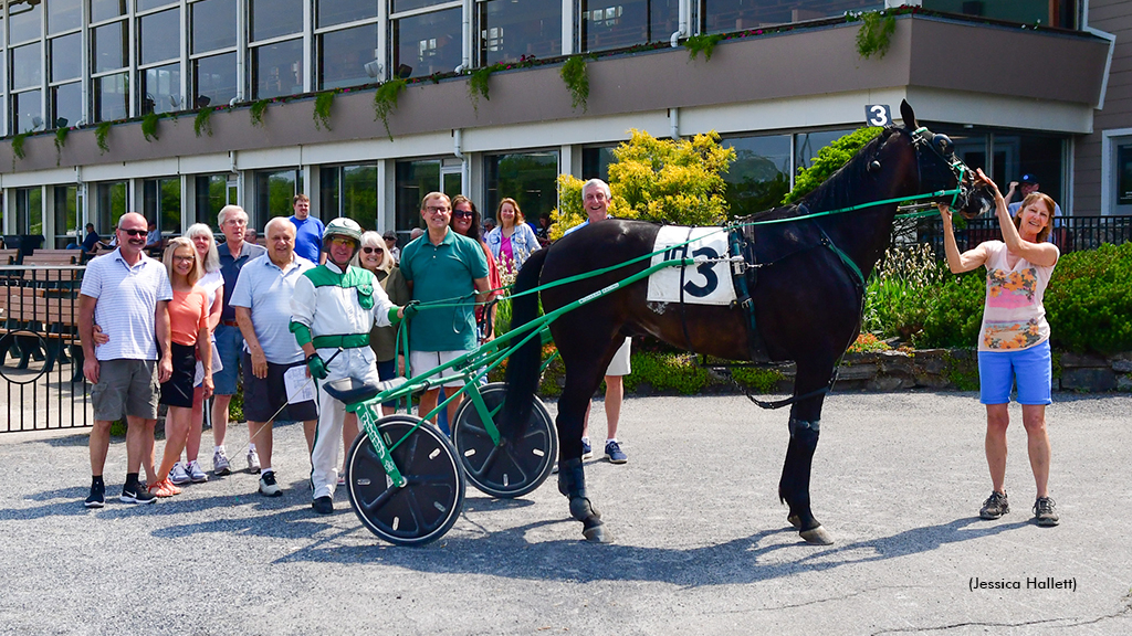 Powerscourt and his connections in the Saratoga winner's circle on June 11. Cheryl McGivern is holding Powerscourt.