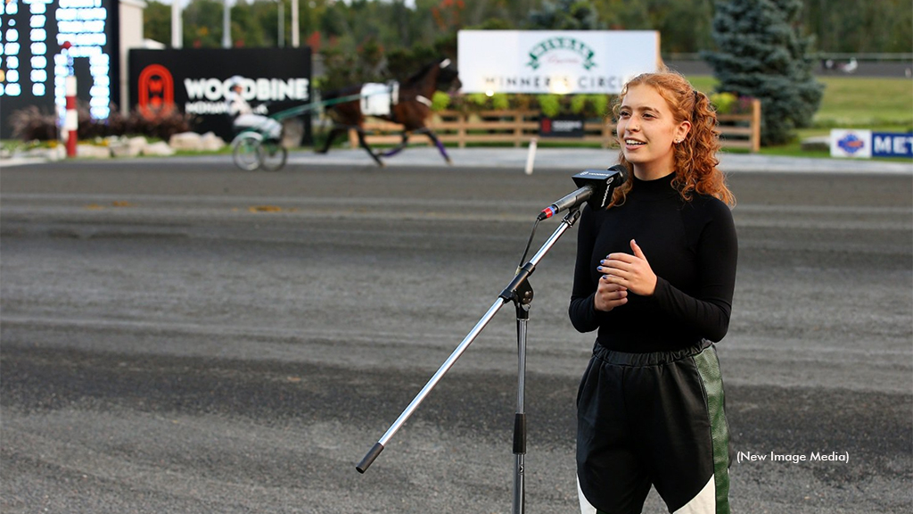 The National Anthem being performed by a singer at Woodbine Mohawk Park