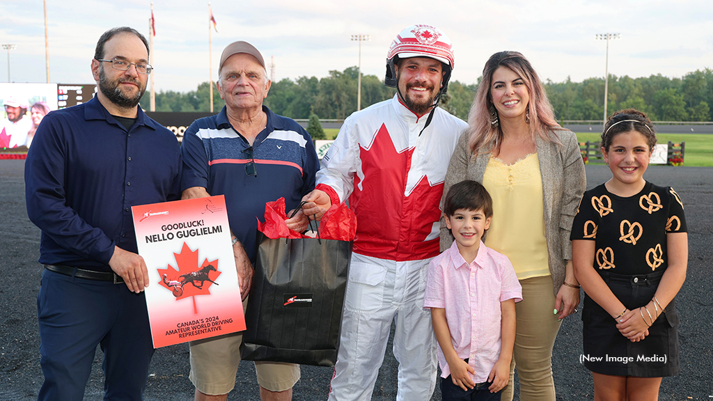Darryl Kaplan and Bill O'Donnell making a special presentation to Nello Guglielmi, joined by his family