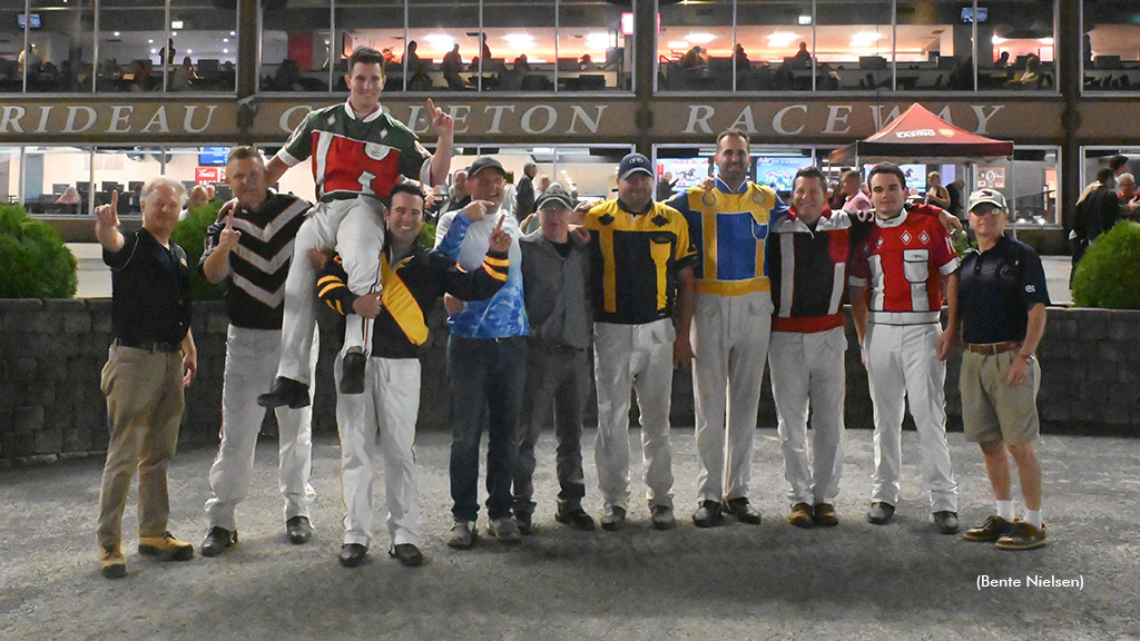 Antonio Vecchio sits on the shoulders of his fellow drivers in the winner's circle