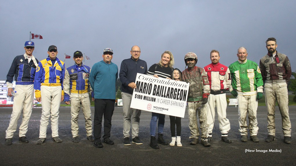 Mario Baillargeon in the winner's circle accepting a presentation for his milestone