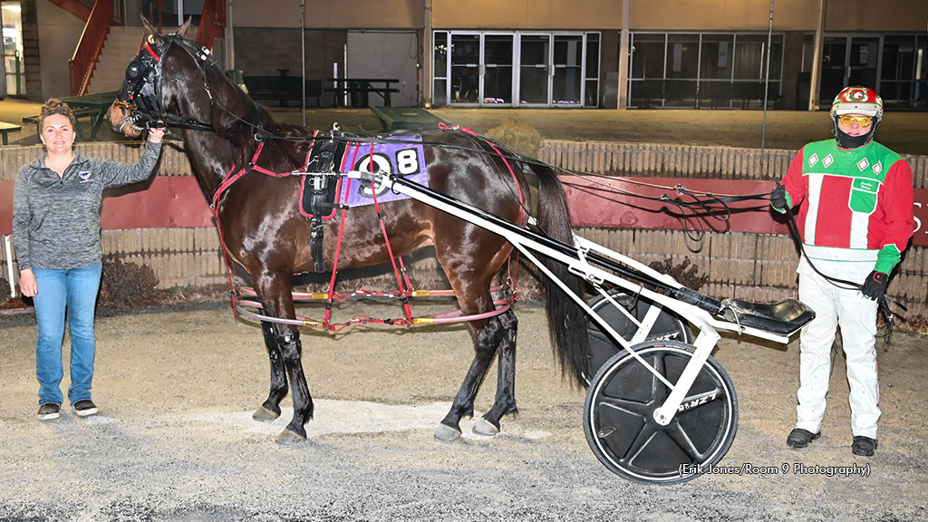 Jonathan Roberts celebrates his 5,000th career driving win in the winner's circle at Rosecroft Raceway