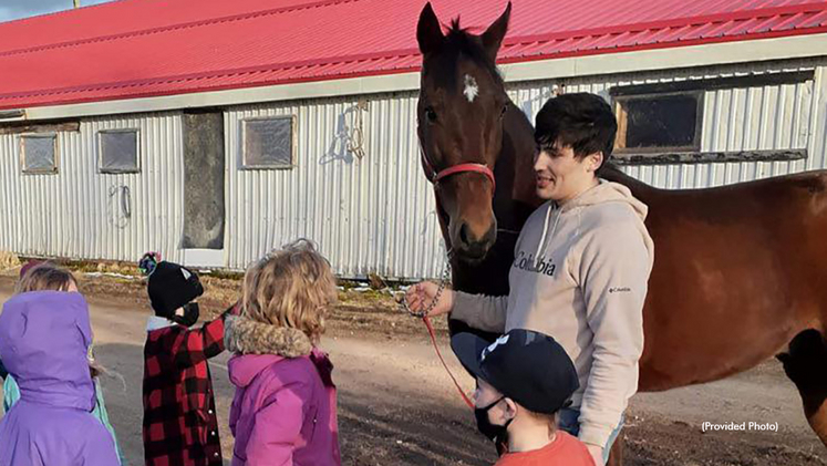 A group of 4-H Cloverbud youths visit the Rennison Stable