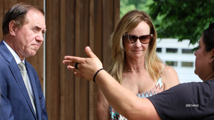 Speaker Craig Coughlin and Julie Miller listen as Heather Zitone gives her tour of Fair Winds Farm.