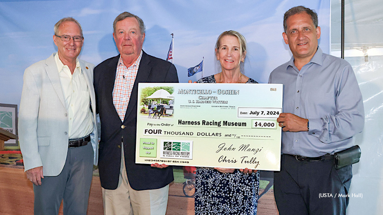 Chris Tully (R) & Shawn Wiles (L) present a cheque for $4,000 to the Harness Racing Museum’s Janet Terhune and Larry DeVan