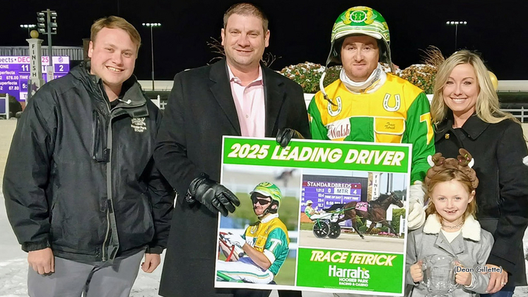 Trace Tetrick receiving a presentation for leading driver