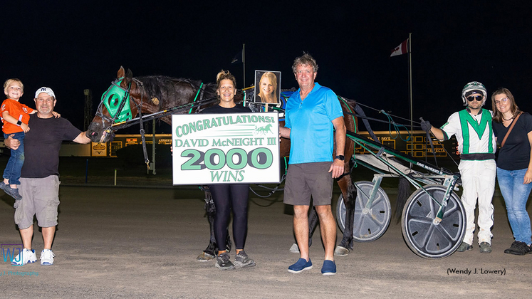 Dave McNeight III in the winner's circle with friends, family and winning connections