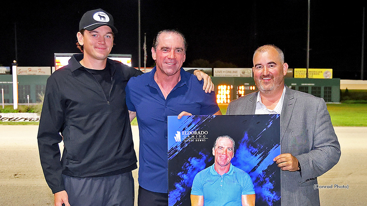 Virgil Morgan Jr. receives the presentation from Jason Roth